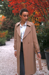 a lady in a double-breasted coat with a belt